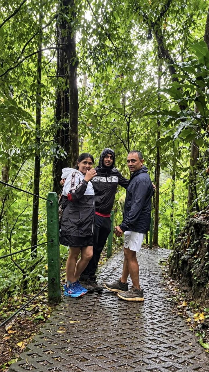 Family walking a rainforest trail with their guide near La Fortuna