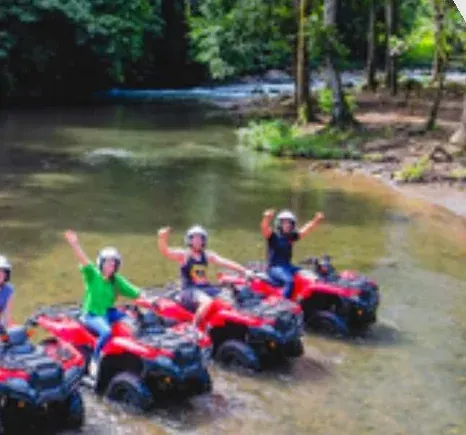 ATV group posing beside the forest river
