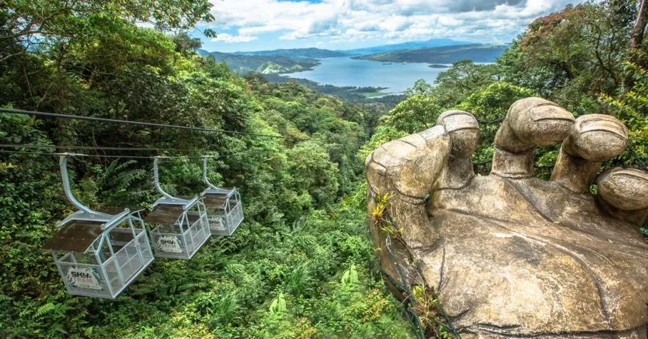 Guest gliding on a Sky Adventures zipline cable, Arenal