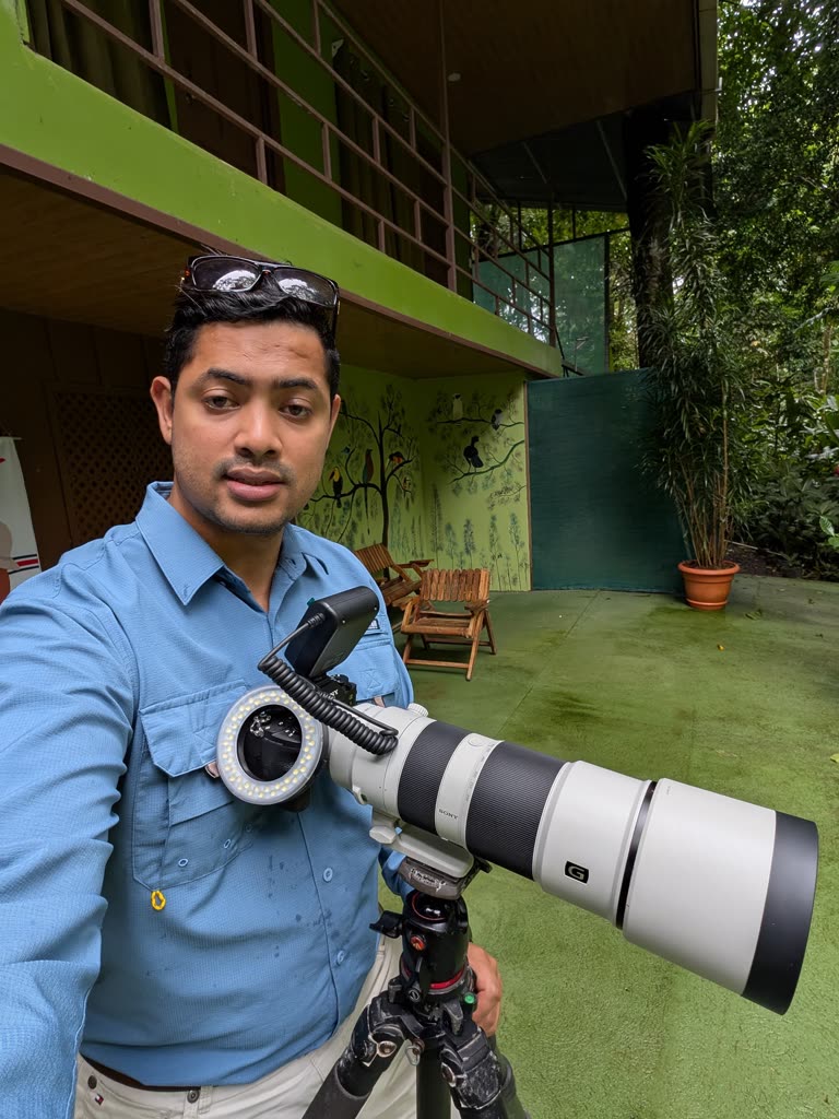 Elias Peña, naturalist guide and wildlife photographer, with his camera and telephoto lens in La Fortuna, Costa Rica